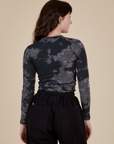 Long Sleeve Baby Tee in Black Magic Waters back view on Alex