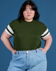 Ashley is wearing Painted Vintage Tee in Evergreen tucked into light wash Wide Leg Trousers