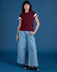 Alex is wearing Painted Vintage Tee in Red Wine and light wash Wide Leg Trousers
