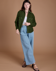 Alex is wearing Cropped Corduroy Overshirt in Evergreen and light wash Indigo Wide Leg Trousers