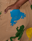 Close up of Kandia's hand in the back pocket of Paintstamped Work Pants in Froggy