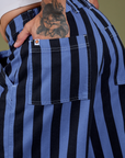 Close up of Jesse's hand in the back pocket of Longline Work Shorts in Cornflower