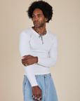 Jerrod is 6’3” and wearing S Long Sleeve Baby Tee in Vintage Tee Off-White