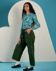 Side view of Long Sleeve Baby Tee in Angel Print and evergreen Drop Pocket Cargo Pants on Shahana