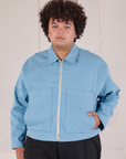 Miguel is wearing a zipped up Mechanic Jacket in Baby Blue