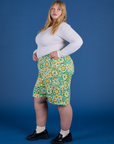 Side view of Longline Work Shorts in Spring Quilt Print and vintage tee white Long Sleeve Baby Tee on Juliet