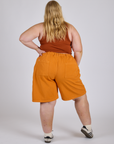 Longline Work Shorts in Creamsicle Orange back view on Juliet