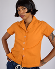 Kira is 5’10” and wearing P Pantry Button-Up in Creamsicle Orange