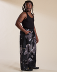 Side view of Magic Waters Drop Pocket Pants in Ink Blot and black Cropped Tank on Demi