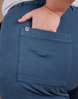 Close up of Juliet's hand in the back pocket of Organic Work Pants in French Blue