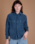 Alex is wearing a buttoned up Cropped Corduroy Overshirt in French Blue