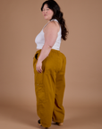 Angled back view of Drop Pocket Cargo Pants in Spicy Mustard on Ashley