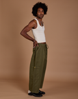 Side view of Drop Pocket Cargo Pants in Surplus Green and Tank Top in Vintage Tee White