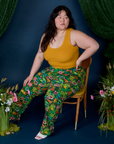 Ashley is sitting in a chair and wearing Work Pants in Pond Party