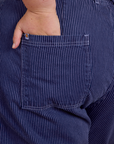 Close up of Juliet's hand in the back pocket of Railroad Denim Work Pants in Faded Grape Overdye