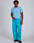saac is 5’10” and wearing M Drop Pocket Cargo Pants in Hawaiian Blue paired with a baby blue Organic Vintage Tee