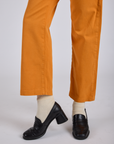 Work Pants in Creamsicle Orange pant leg close up on Kira
