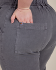 Close up of Ashley's hand in the back pocket of Short Sleeve Jumpsuit in Washed Grey
