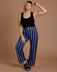 Tiara is 5’4” and wearing S Black Stripe Work Pants in Cornflower Blue