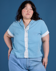 Ashley is wearing a buttoned up Painted Pantry Button-Up in Baby Blue