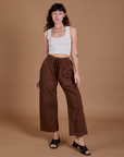 Alex is 5’8” and wearing XXS Drop Pocket Cargo Pants in Fudgesicle Brown paired with a Cropped Tank in vintage tee white
