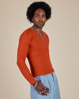 Long Sleeve Baby Tee in Chili Red side view on Jerrod