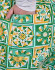 Close up of Juliet's hand in the back pocket of Longline Work Shorts in Spring Quilt Print