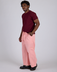 Side view of Drop Pocket Cargo Pants in Baby Pink and red wine Organic Vintge Tee on Isaac