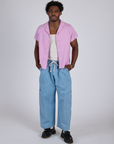 Isaac is wearing Pantry Button-Up in Lilac Purple and light wash Denim Drop Pocket Pants