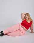 Juliet is wearing Work Pants in Baby Pink and mustang red Cropped Tank