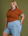 Angled front view of Vintage Ringer Tee in Burnt Terracotta and light wash Carpenter Shorts