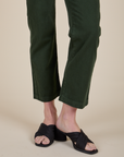 Short Sleeve Jumpsuit in Swamp Green pant leg close up on Alex