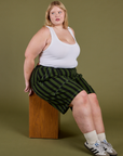 Juliet is wearing Longline Work Shorts in Evergreen and vintage tee white Cropped Tank