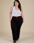Ashley is wearing Work Pants in Basic Black and vintage tee white Cropped Tank