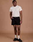 Isaac is 5’10” and wearing M Classic Work Shorts in Basic Black paired with an Organic Vintage Tee in Vintage Off White