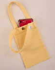 Phone tucked into butter yellow Cell Phone Tote