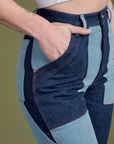 Close up of Alex's hand in the front pocket of Mismatched Denim Carpenter Jeans