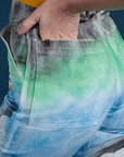 Close up of Alex's hand in the back pocket of Work Pants in Night Sky Airbrush