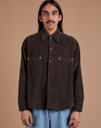 Anthony is wearing a buttoned up Cropped Corduroy Overshirt in Espresso Brown