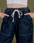 Close up of Denim Drop Pocket Pants in Dark Wash with Alex's hands in the front pockets