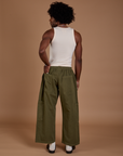 Back view of Drop Pocket Cargo Pants in Surplus Green and Tank Top in vintage tee white on Jerrod