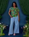 Kandia is wearing Pond Party Pantry Button-Up and Indigo Wide Leg Trousers in Light Wash
