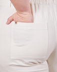 Back pocket close up of Petite Short Sleeve Jumpsuit in Vintage Tee Off-White. Ashley had her hand in the pocket.