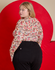 Angled back view of Long Sleeve Baby Tee in Hot Stuff Print on Juliet