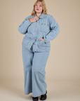 Juliet is wearing Indigo Denim Work Jacket in Light Wash and light wash Indigo Wide Leg Trousers