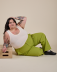 Work Pants in Gross Green and vintage tee white Cropped Tank on Sam