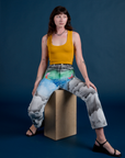 Alex is wearing Work Pants in Night Sky Airbrush and mustard yellow Tank Top
