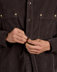 Cropped Corduroy Overshirt in Espresso Brown close up of Anthony buttoning up the shirt