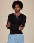 Jerrod is 6’3” and wearing S Long Sleeve Baby Tee in Basic Black