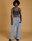 Jerrod is wearing Mini Tank in Lagoon and light wash Indigo Wide Leg Trousers